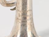a silver trumpet that is sitting on a table