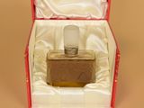 a red box with a bottle of perfume inside of it