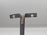 a pair of black sued earrings with gold studs
