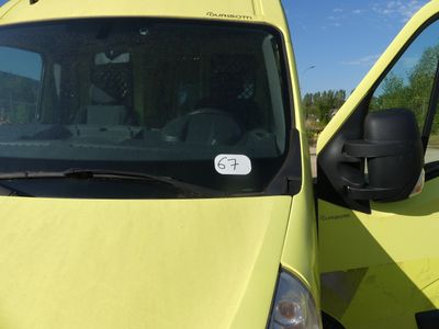 a yellow van that is parked in a parking lot