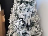 a white christmas tree and a brown bag on the floor