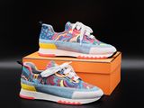a pair of colorful sneakers on top of an orange box
