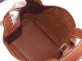 a brown bag with a white handle and a white glove inside of it
