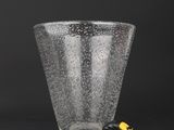 a close up of a glass with a measuring tape next to it