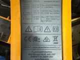 the back of a yellow and black vehicle with a battery attached to it