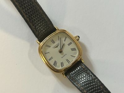 an image of a close up of a wrist watch with roman numerals