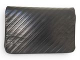 a black leather clutch bag on a white background