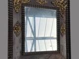 a picture of a mirror that is hanging on the wall