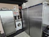 a refrigerator and a washer in a small kitchen