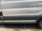 a silver van with a broken door on the side of the road