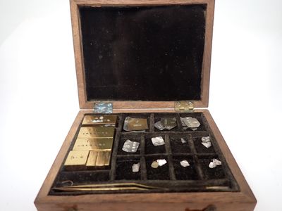 a small wooden box with many different items inside of it