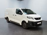 the white van is parked in a large room with a ceiling fan