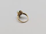 a close up of a gold ring with a pearl in it