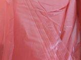 a pink plastic bag that is sitting on the floor