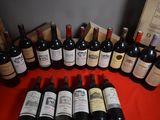 many bottles of wine sitting on a red table