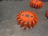 four orange gears on a metal surface with a blue background