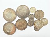 a pile of coins sitting on top of a white surface