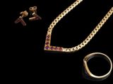 two pieces of jewelry are shown on a black surface