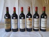 six bottles of wine are lined up in a row on a table