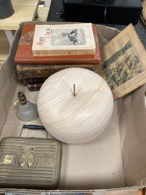 a box full of books and a candle on a table