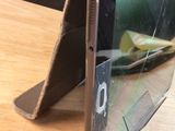 a cell phone with a broken screen on a table