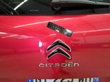 a red car with a sticker on the front of it