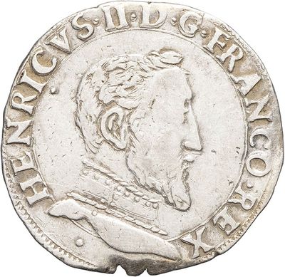 a silver coin with a man ' s face on it