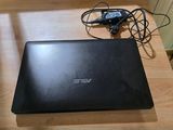 an open laptop computer sitting on top of a wooden table