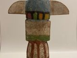 sculpture of a person with a horned head on a black base
