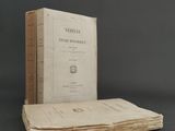 an old book sitting on top of a stack of books