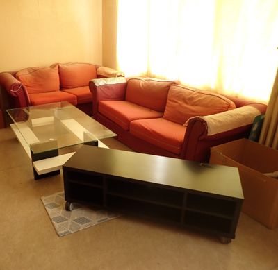 a living room with a couch, coffee table, and a television