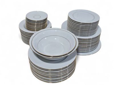 a stack of plates and bowls on a white table