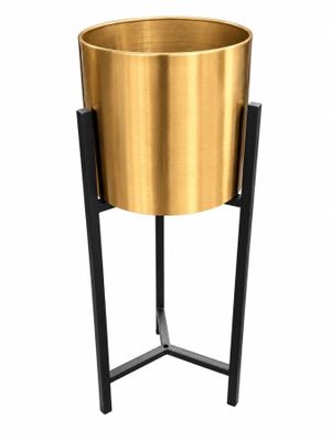 a gold planter on a black stand with a white background