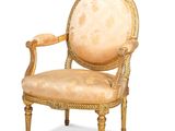 an image of a chair with a beige upholstered seat and gold trim