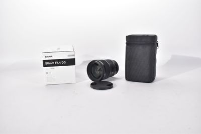 the camera is sitting next to the box of the lens