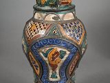 a vase with a lid on a gray background