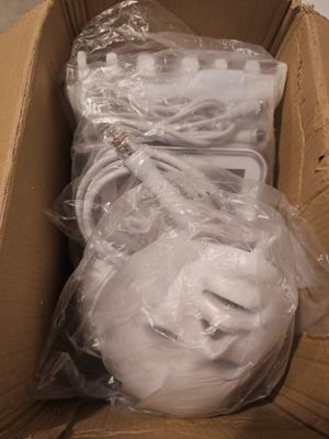 a cardboard box filled with white items and wrapped in plastic