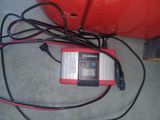 a charger that is plugged into a red container