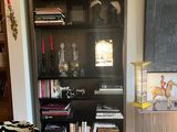 a zebra print chair in a living room next to a book shelf