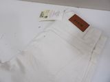 white pants with a brown label on them sitting on a white surface