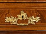 a wooden cabinet with a brass handle and a clock on it