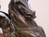 a statue of a horse with a rider on it ' s back