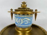 a blue and gold vase sitting on a gold tray