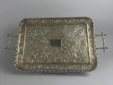 a silver tray with handles and handles on a white surface