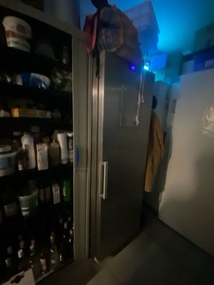 an image of a refrigerator in a room with a lot of bottles