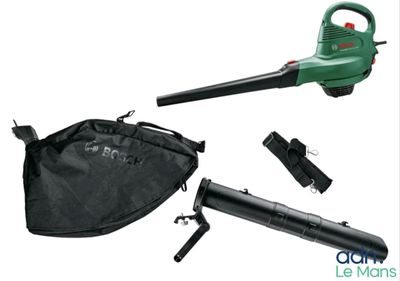 the green leaf blower is sitting next to a black bag