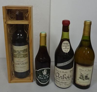 several bottles of wine are lined up in a row next to a wooden box