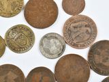 a lot of coins that are on a white surface