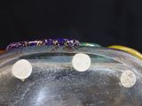 a glass bowl with a colorful object inside of it