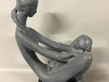 a statue of a woman holding a baby in her arms